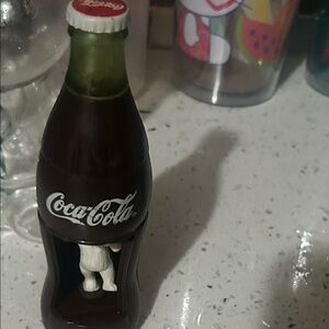 Coca-Cola Bottle with White Figurine